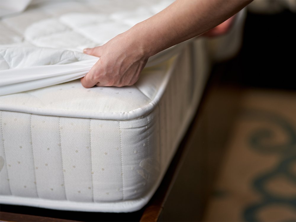 Mattress encasement being fitted over mattress